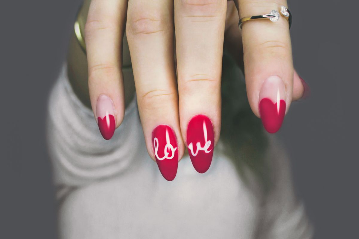 Custom red nail art by Nail Therapy Beauty Boutique